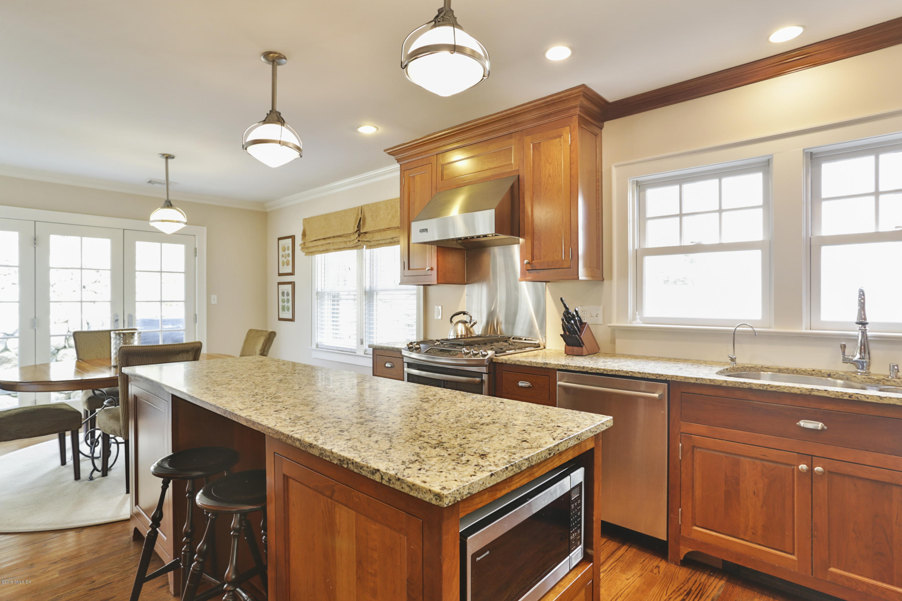 36 Valleywood Road Cos Cob, CT 06830 - Photo 11 of 45 a kitchen with center island table and chairs