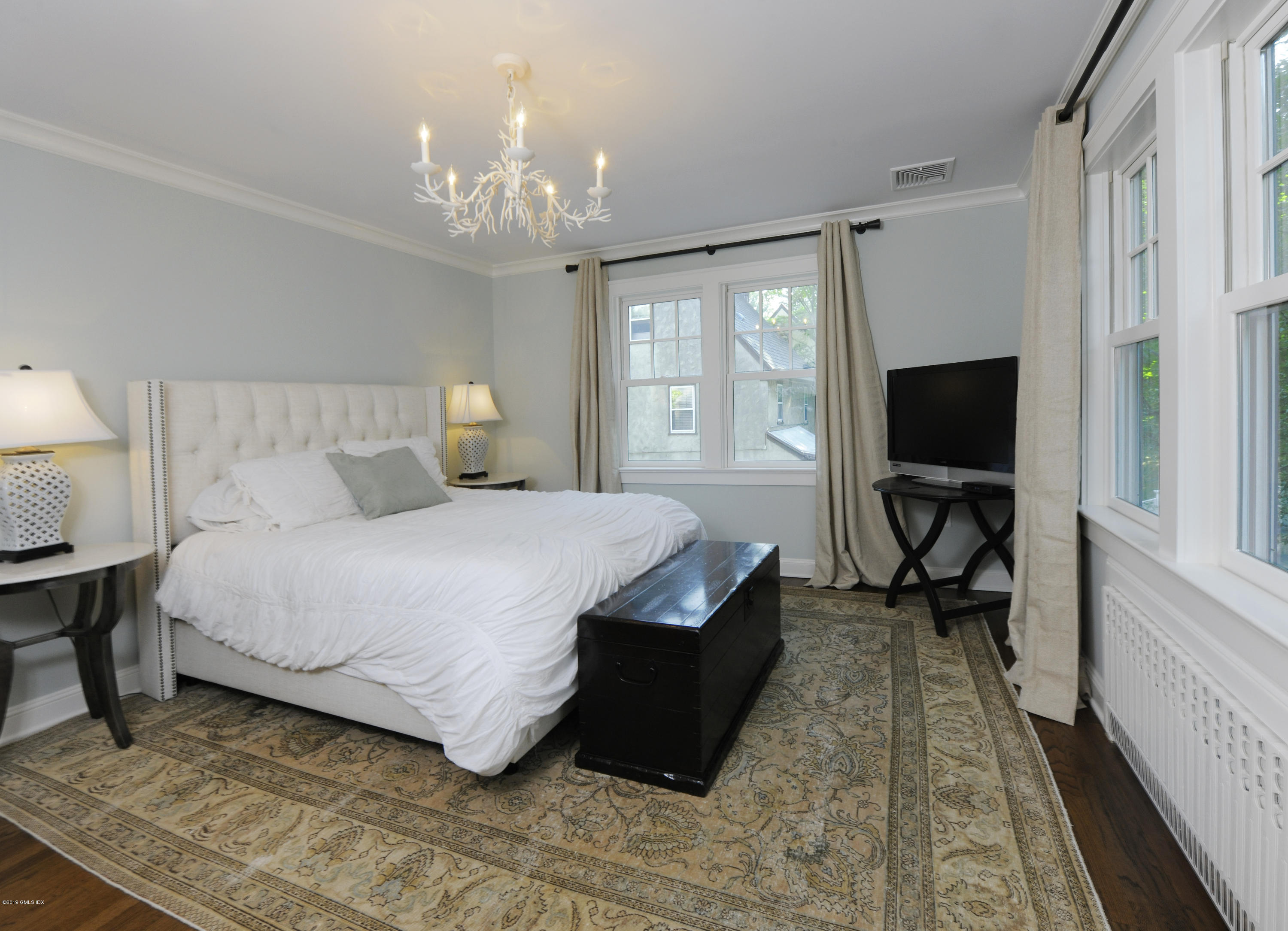 36 Valleywood Road Cos Cob, CT 06830 - Photo 20 of 45 a bedroom with a bed flat screen tv and a large window
