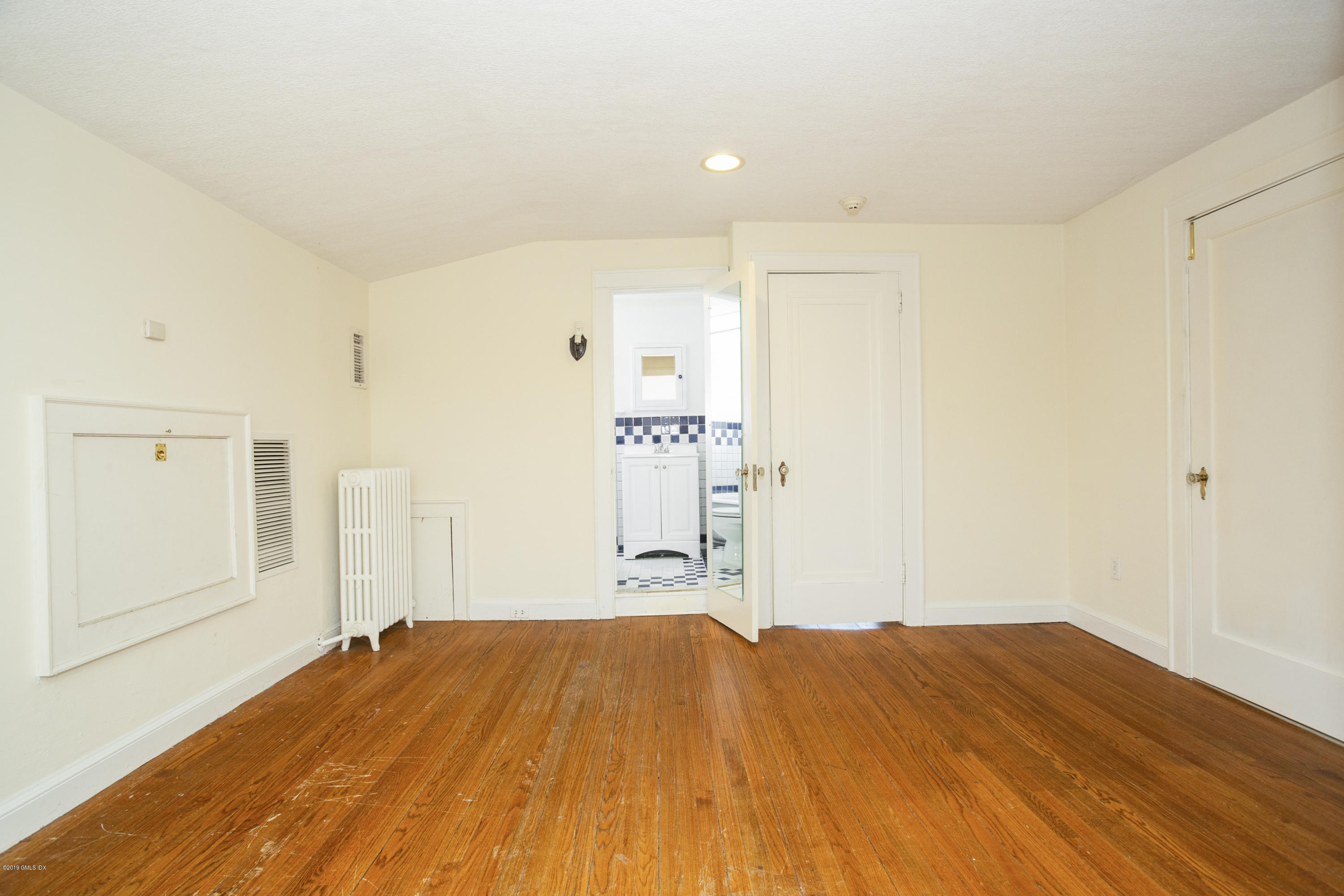 36 Valleywood Road Cos Cob, CT 06830 - Photo 28 of 45 a bedroom with a bed and wooden floor