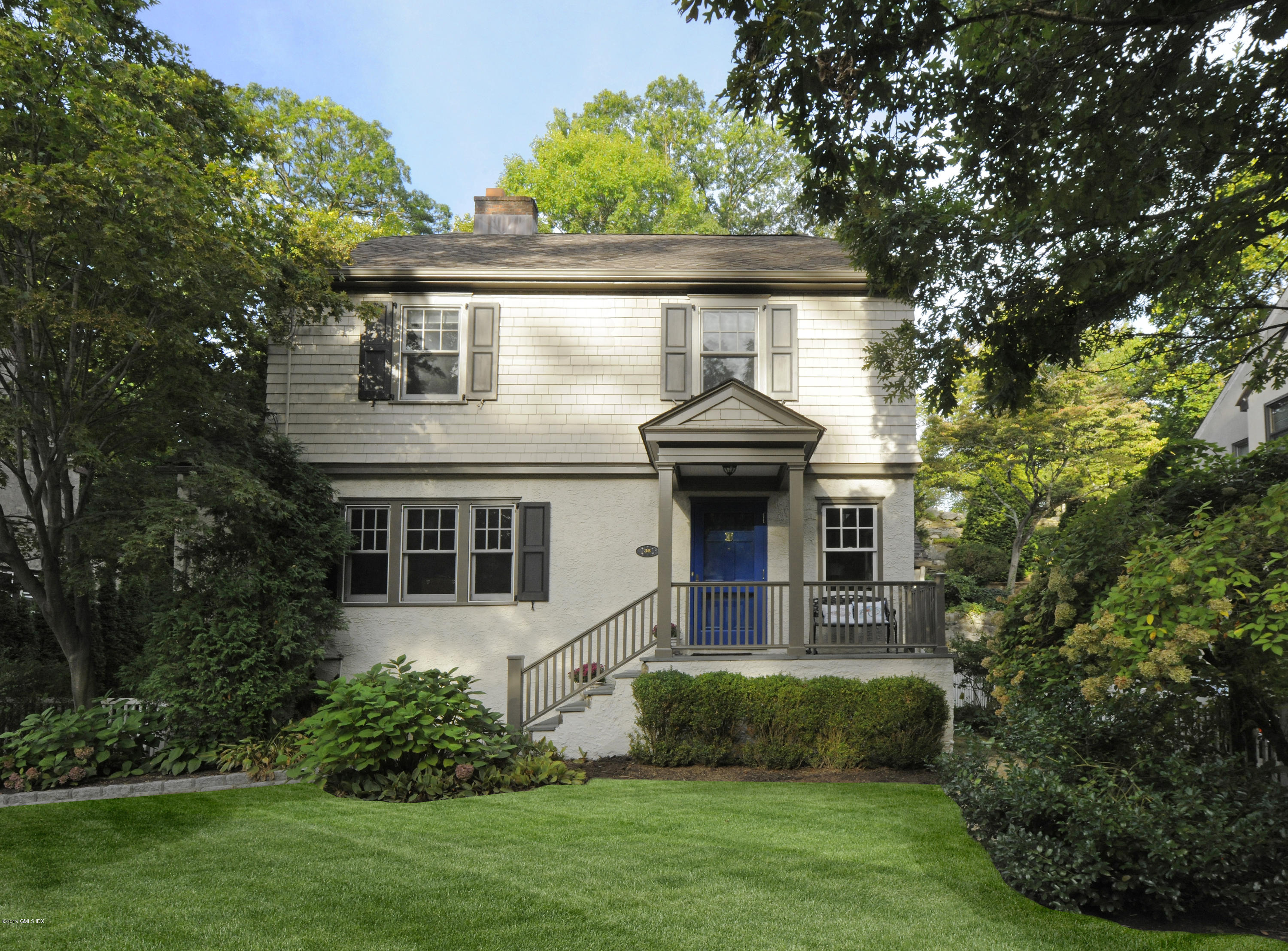 36 Valleywood Road Cos Cob, CT 06830 - Photo 37 of 45 a front view of a house with a garden