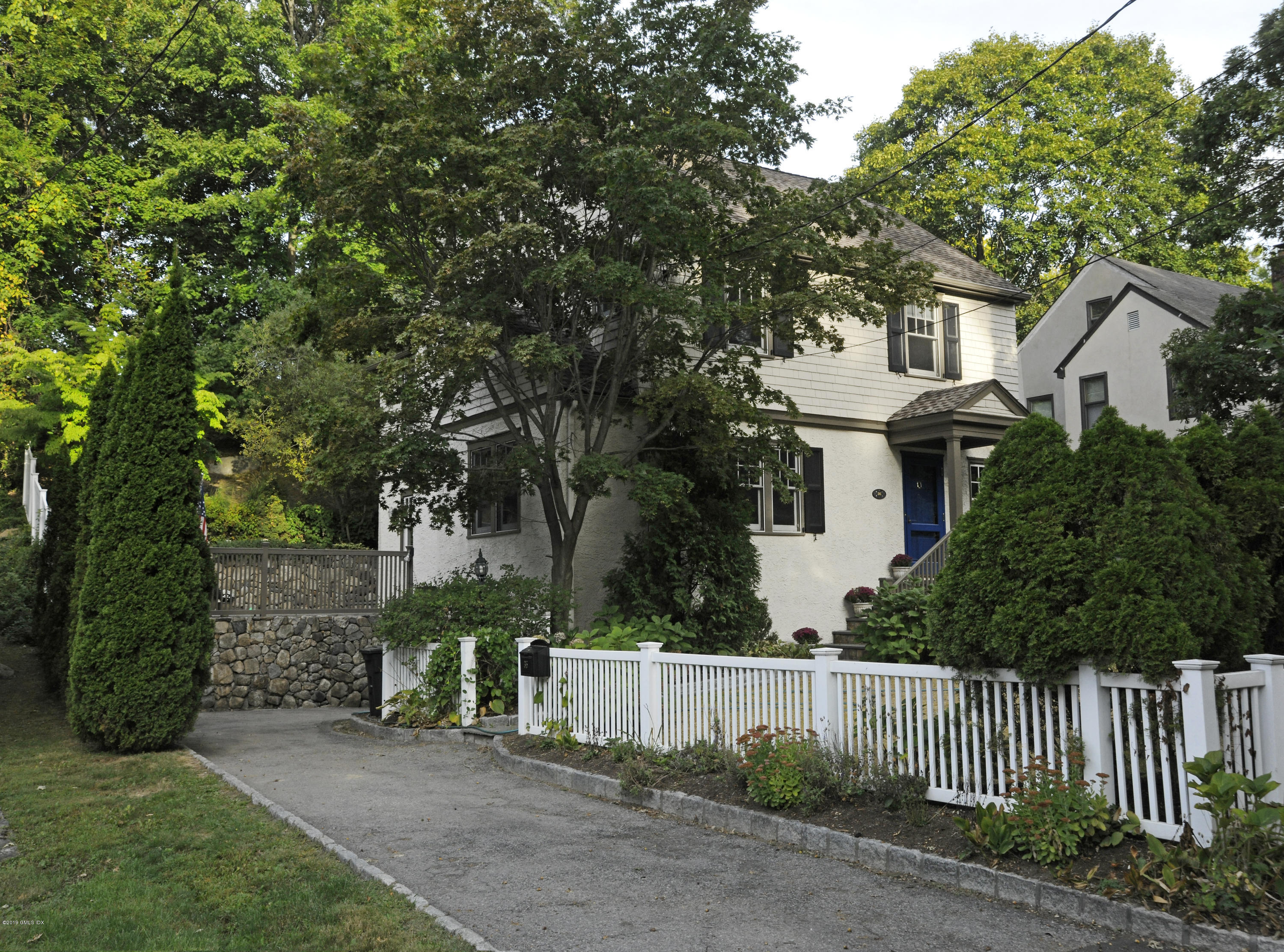 36 Valleywood Road Cos Cob, CT 06830 - Photo 40 of 45 a front view of a house with a garden