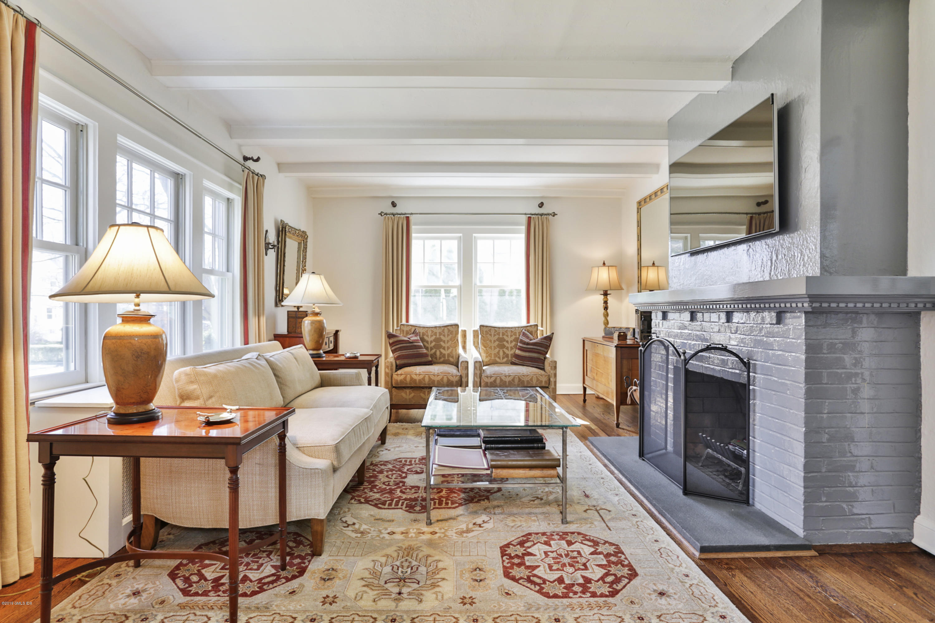 36 Valleywood Road Cos Cob, CT 06830 - Photo 6 of 45 a living room with furniture a fireplace and a flat screen tv