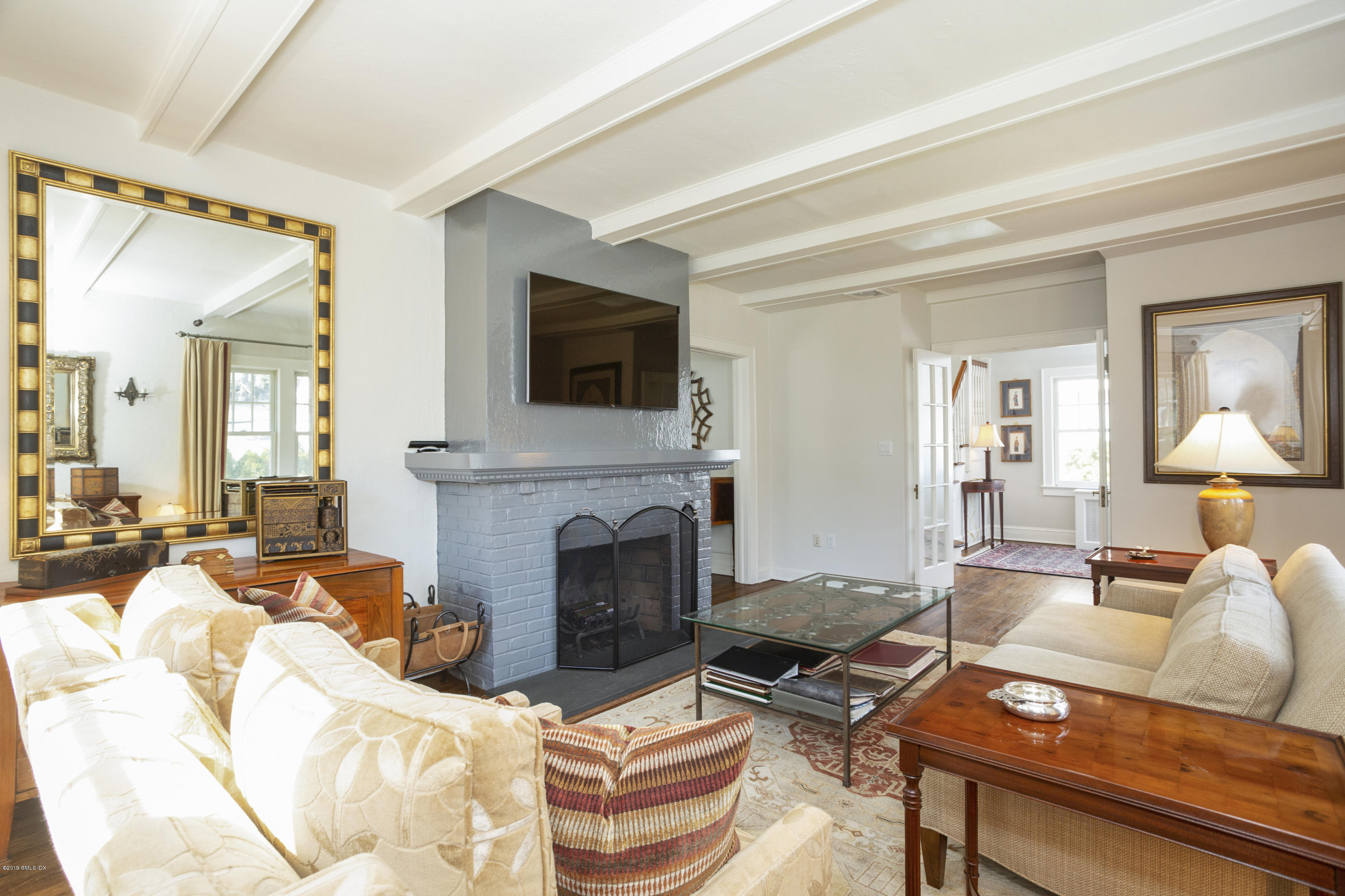 36 Valleywood Road Cos Cob, CT 06830 - Photo 7 of 45 a living room with furniture a flat screen tv and a fireplace