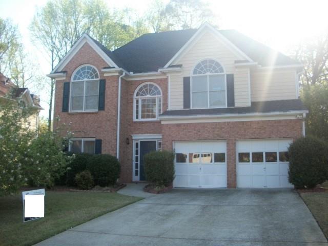 2846 Colleton Drive Marietta, GA 30066 - Photo 7 of 7 a front view of a house with a garden and garage