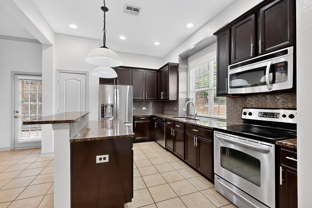 4015 Rome Court Irving, TX 75038 - Photo 1 of 24 a kitchen with stainless steel appliances granite countertop a stove a sink and a refrigerator