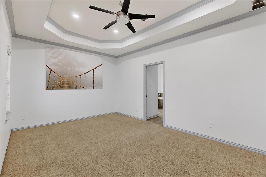 4015 Rome Court Irving, TX 75038 - Photo 12 of 24 en empty room with ceiling fan and windows