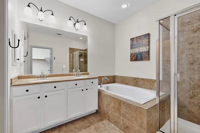 a bathroom with a tub sink and mirror