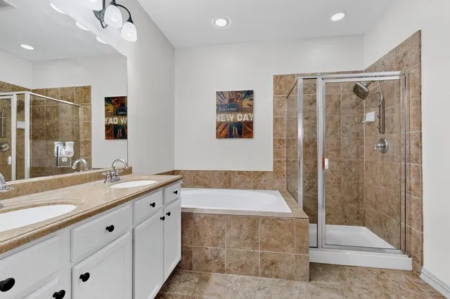 a bathroom with a granite countertop sink a large mirror and shower