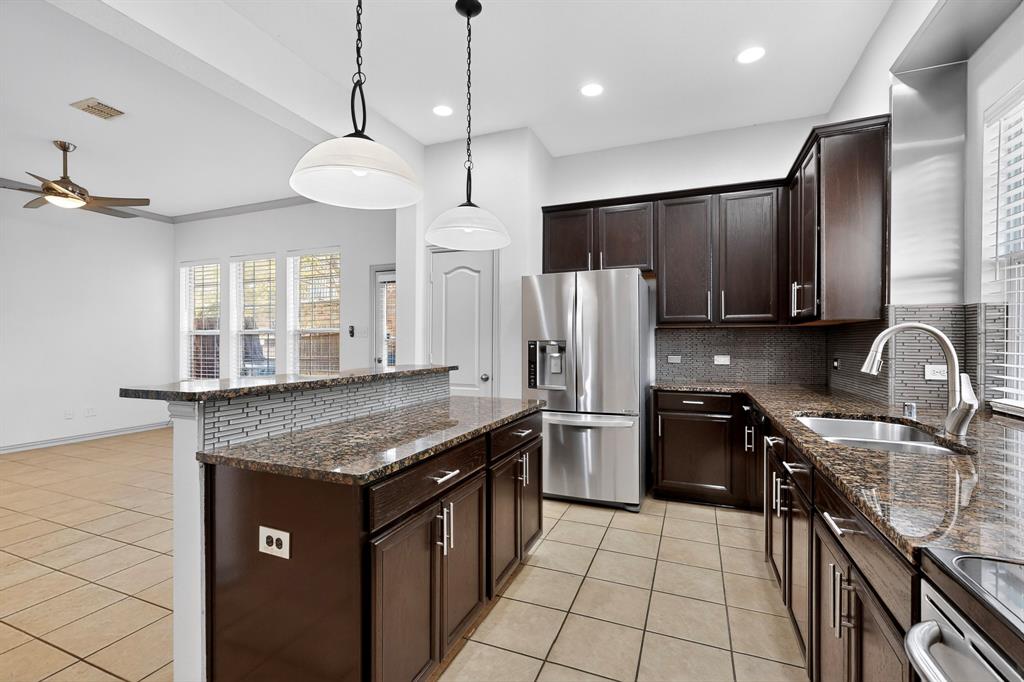 4015 Rome Court Irving, TX 75038 - Photo 4 of 24 a kitchen with stainless steel appliances granite countertop a sink stove and refrigerator