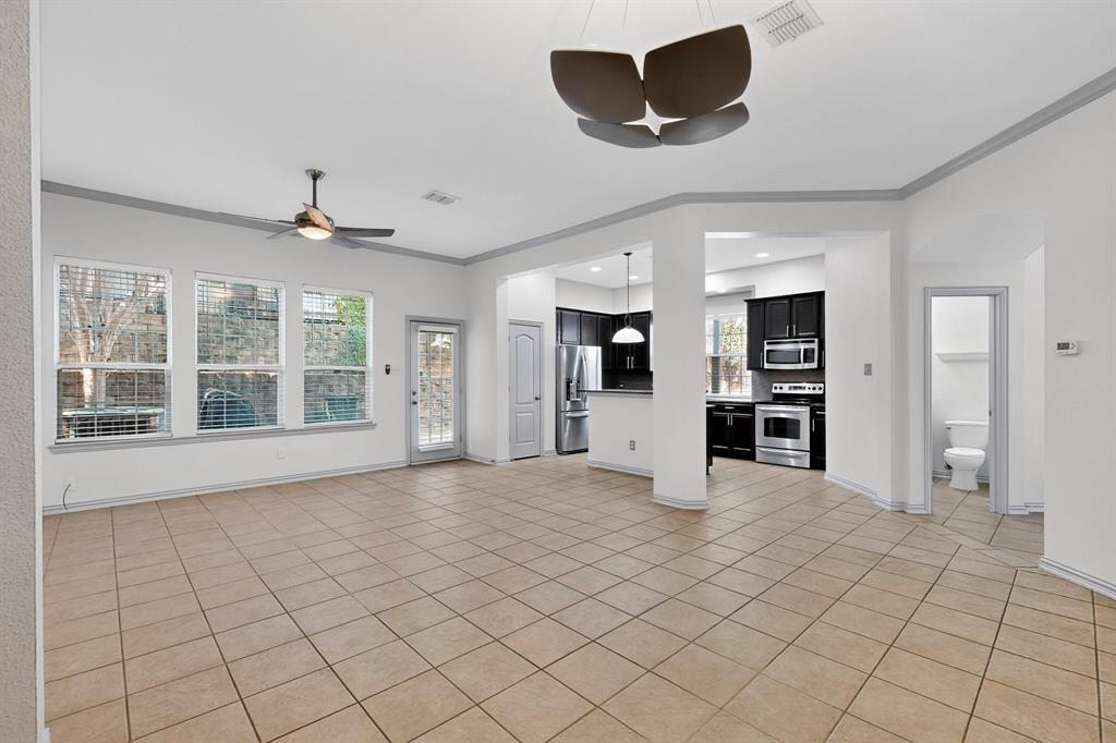 4015 Rome Court Irving, TX 75038 - Photo 6 of 24 a view of an empty room with a window and kitchen view