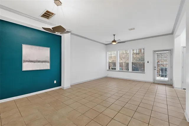 a view of an empty room with window and cabinet