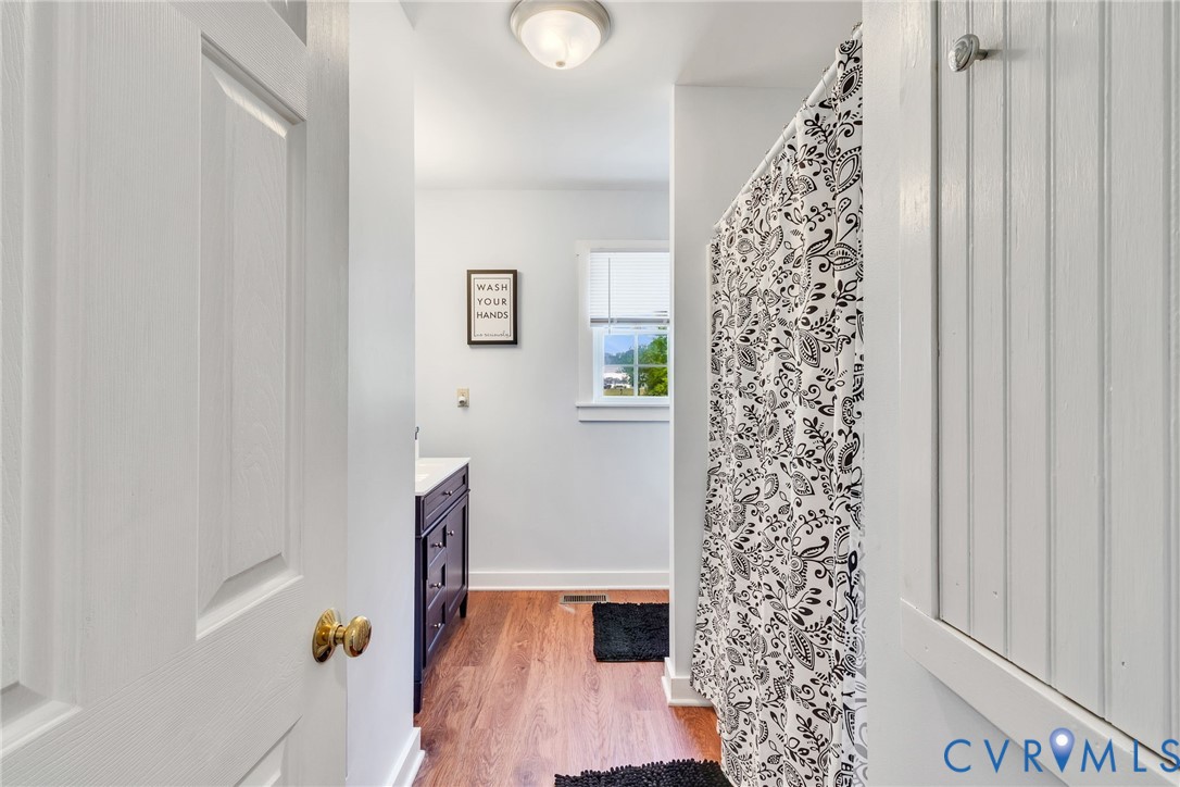 193 Deep Water Lane Reedville, VA 22539 - Photo 15 of 84 a bathroom with a shower curtain and a large window