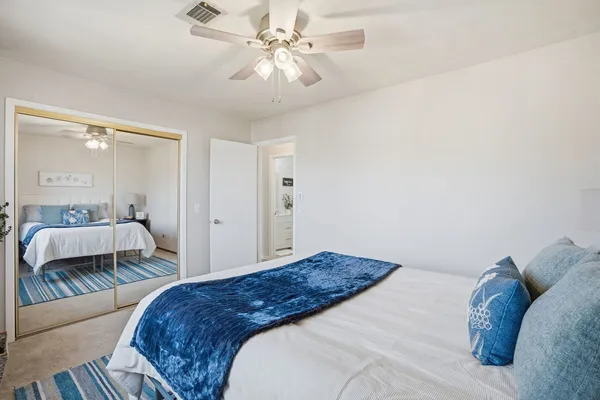 a bedroom with a large bed and a chandelier