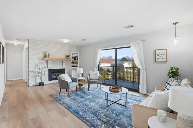 a living room with furniture and a floor to ceiling window