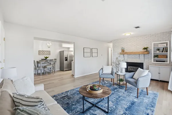 a living room with furniture a rug and a fireplace