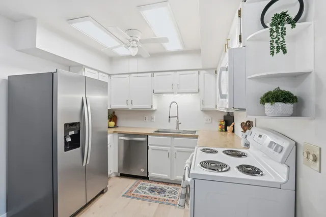 a kitchen with a white stainless steel appliances cabinets and a counter top space