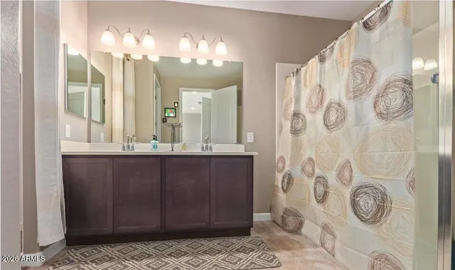 a bathroom with a mirror and a shower