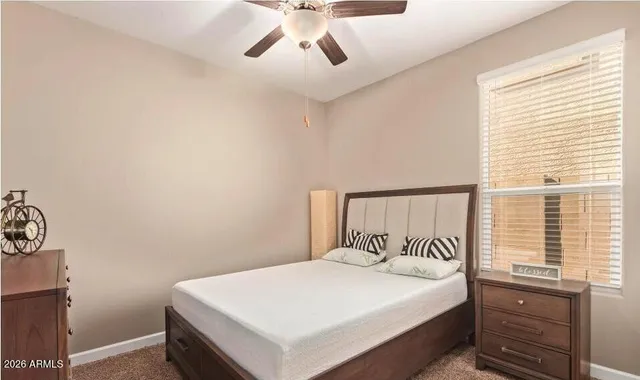 a bedroom with a bed and window