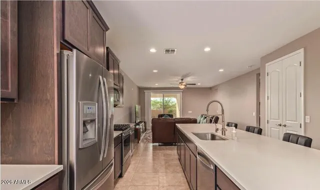 a kitchen with stainless steel appliances a sink stove and refrigerator