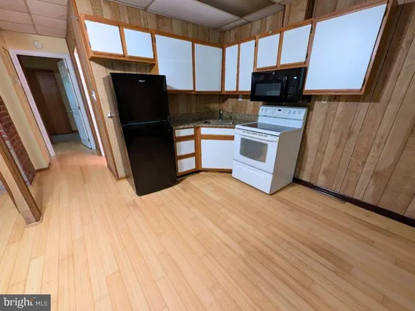 a kitchen with stainless steel appliances a refrigerator a stove a microwave and cabinets