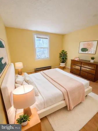 a bedroom with a bed and dresser
