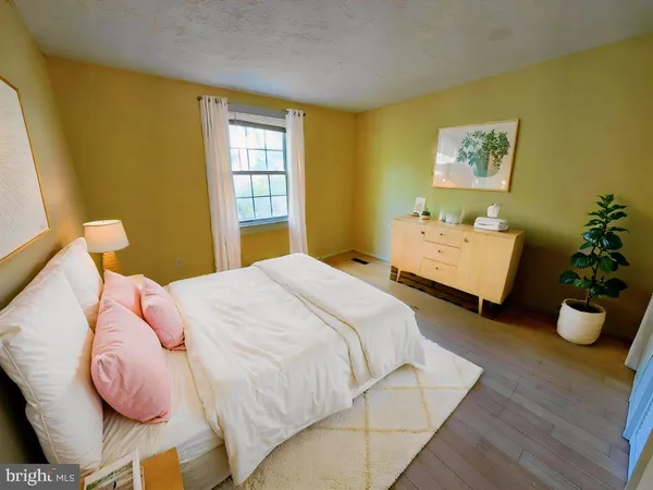 a bedroom with a bed and a potted plant