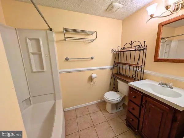 a bathroom with a sink a toilet a mirror and shower