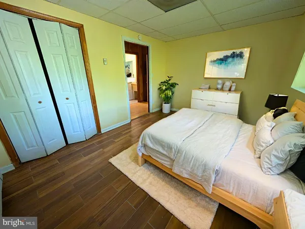 a bedroom with a bed and a mirror