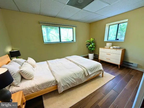 a bedroom with a bed and windows