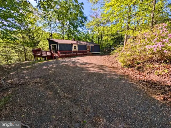 a front view of a house with a yard and a garage