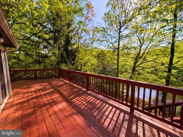 a view of balcony with wooden floor and fence