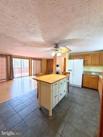 a view of kitchen with stove and cabinets