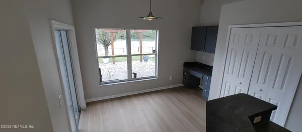 wooden floor in an empty room with a window