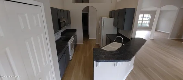 a bathroom with a sink a mirror and shower