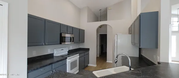 a kitchen with stainless steel appliances a sink stove and refrigerator