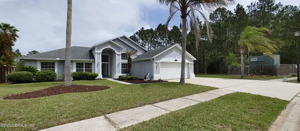 a front view of a house with a yard