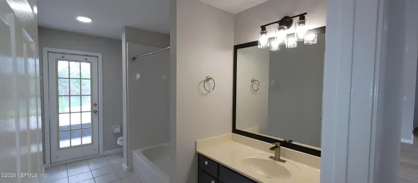 a bathroom with a sink and mirror