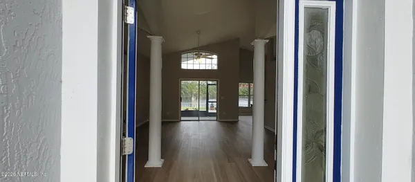 a view of an entryway with wooden floor