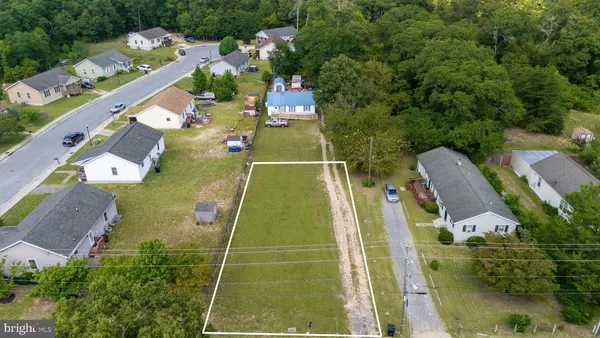 an aerial view of a residential houses with outdoor space