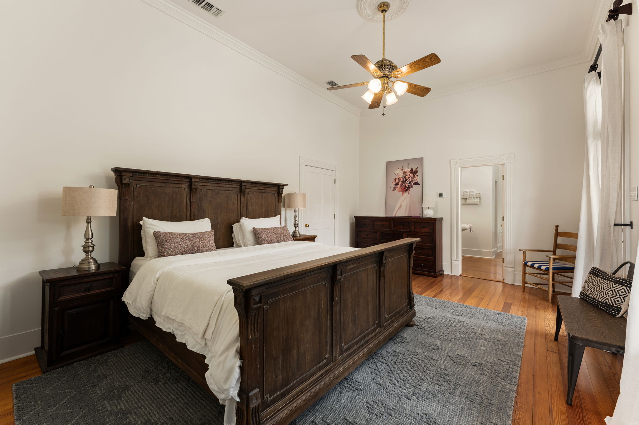 3409 Gatlin Creek Road Dripping Springs, TX 78620 - Photo 14 of 40 a spacious bedroom with a bed and a chandelier