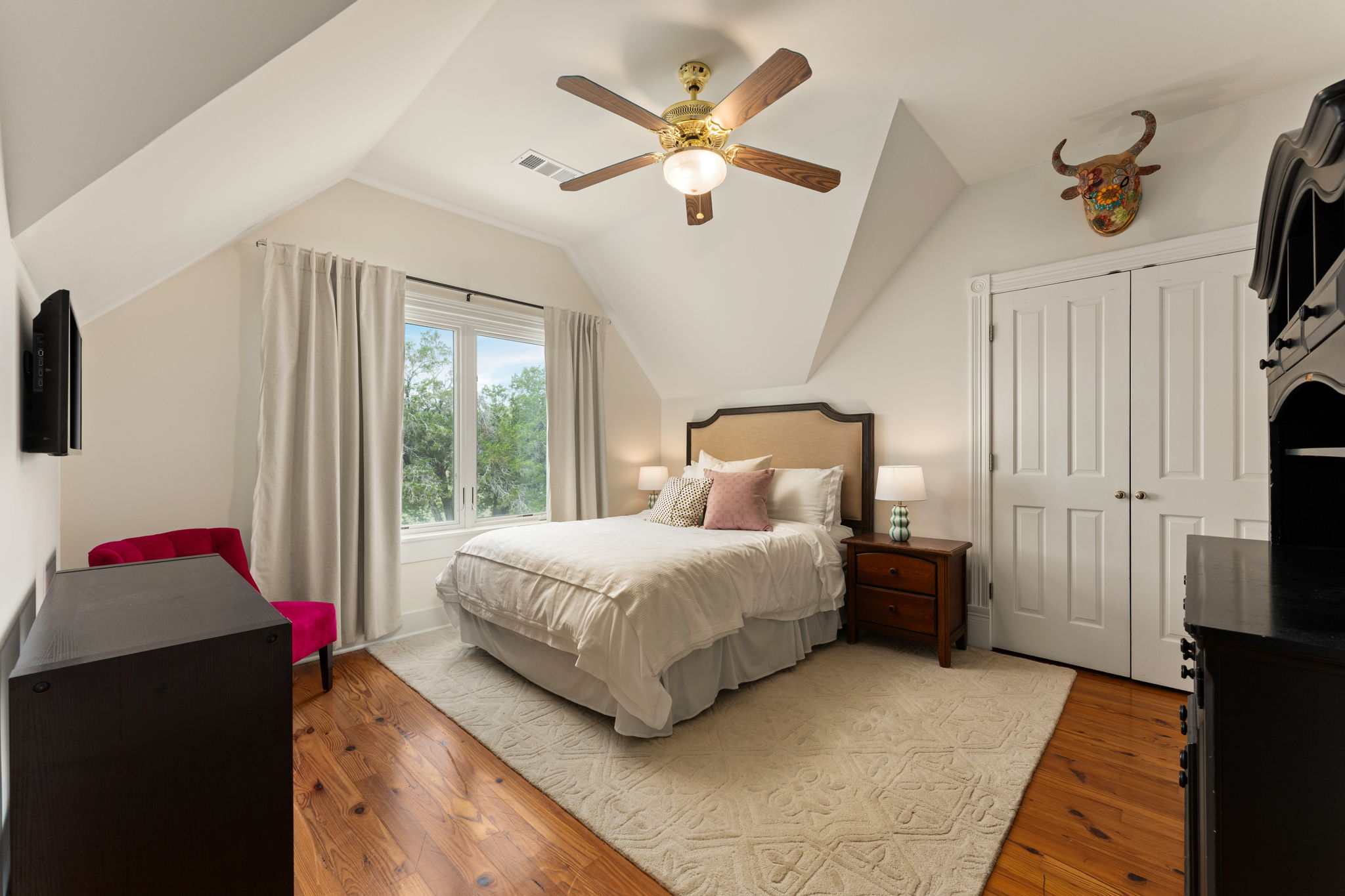 3409 Gatlin Creek Road Dripping Springs, TX 78620 - Photo 21 of 40 a bedroom with a bed and a chandelier