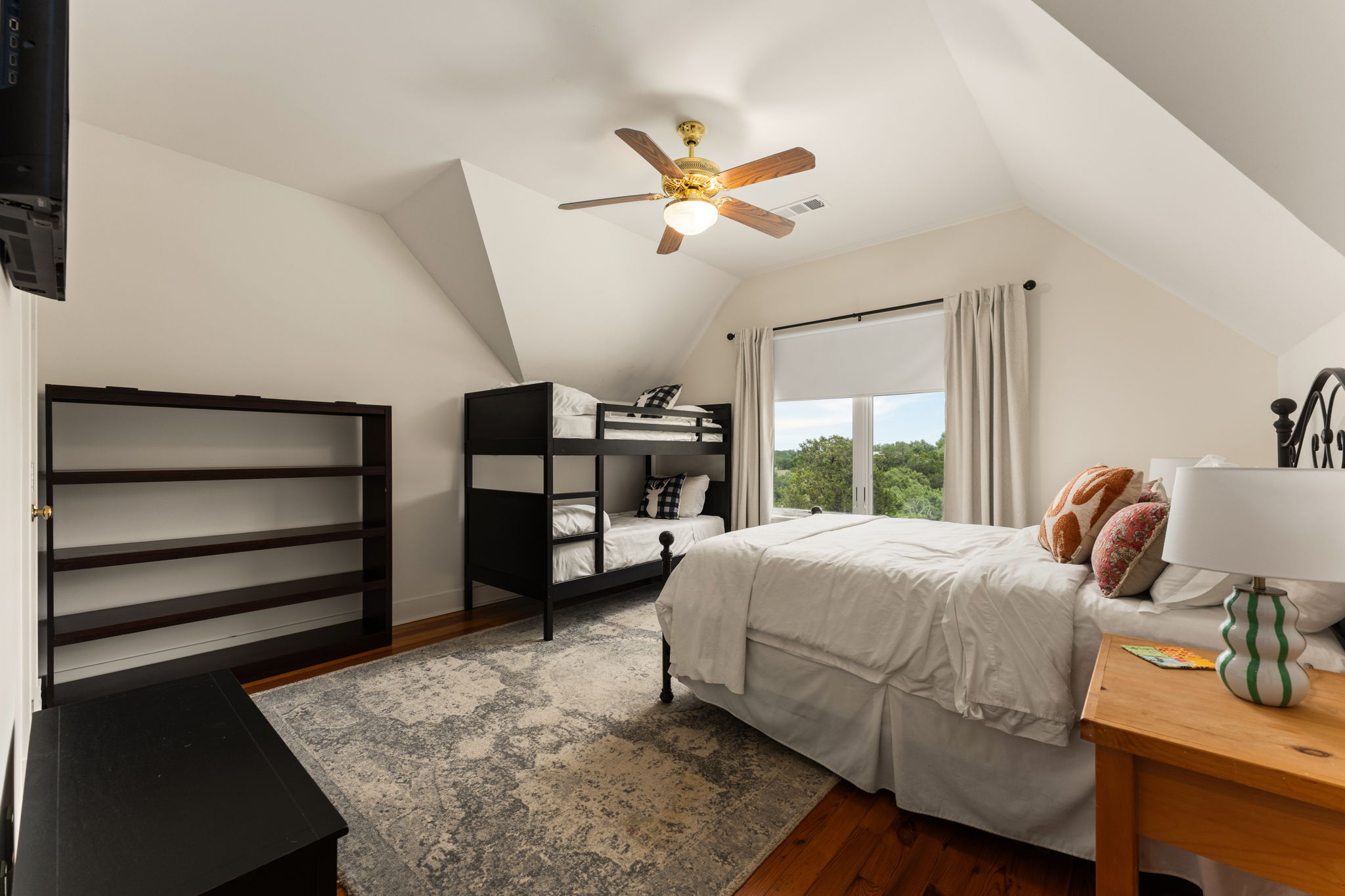 3409 Gatlin Creek Road Dripping Springs, TX 78620 - Photo 24 of 40 a bedroom with a bed and large windows