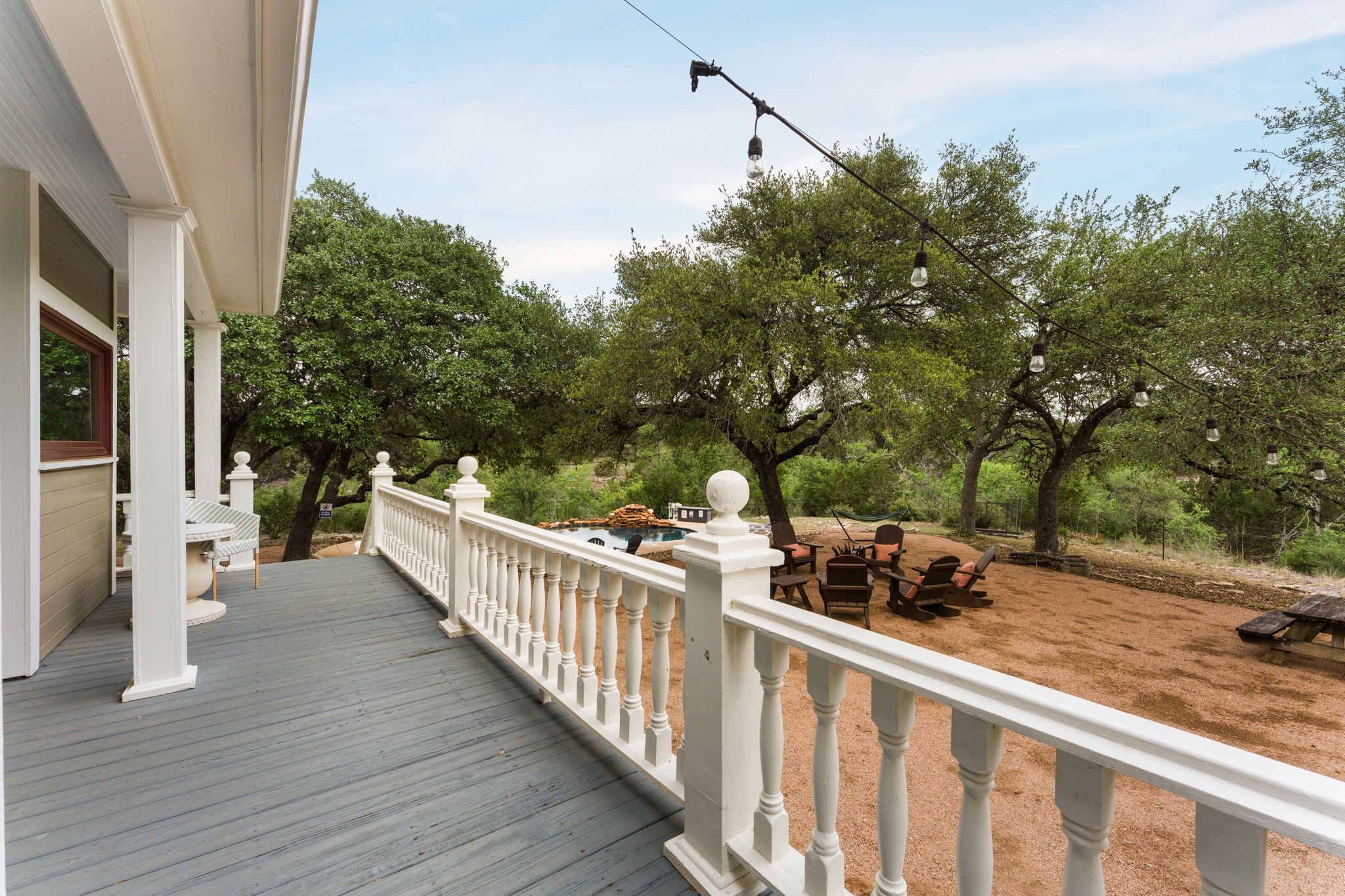 3409 Gatlin Creek Road Dripping Springs, TX 78620 - Photo 25 of 40 a view of a deck with couches and wooden fence