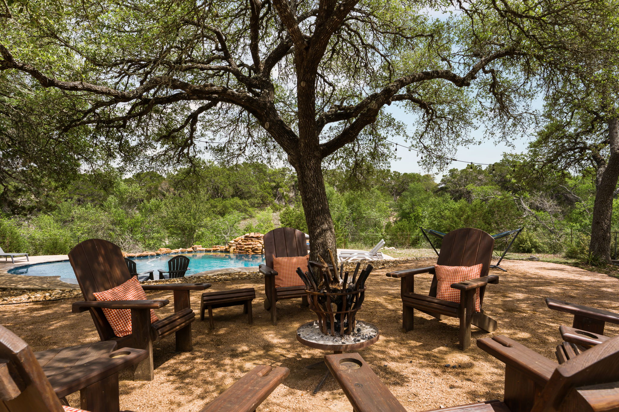 3409 Gatlin Creek Road Dripping Springs, TX 78620 - Photo 27 of 40 a view of a patio with table and chairs and floor to ceiling window