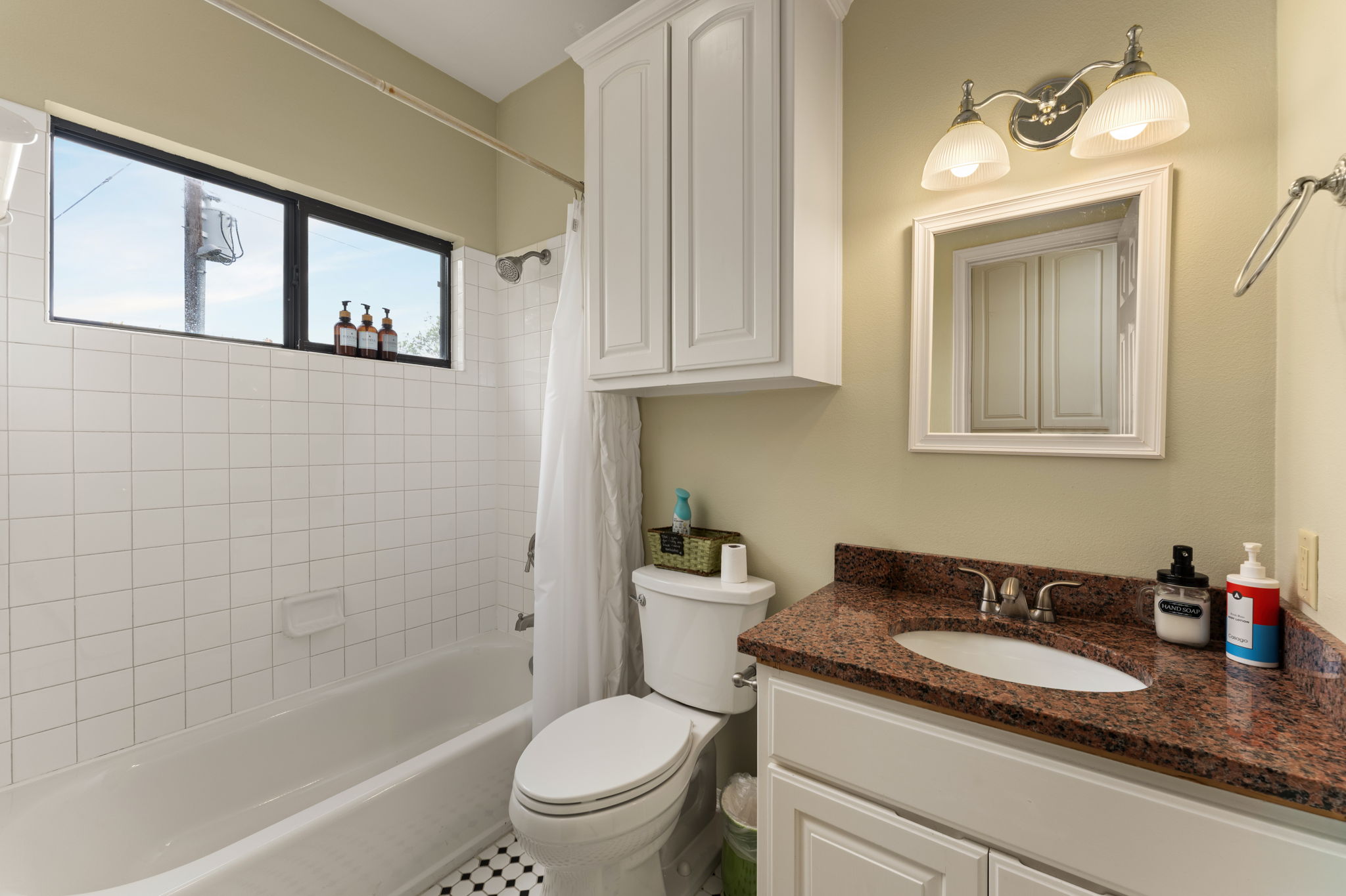 3409 Gatlin Creek Road Dripping Springs, TX 78620 - Photo 36 of 40 a bathroom with a granite countertop sink a toilet and bathtub