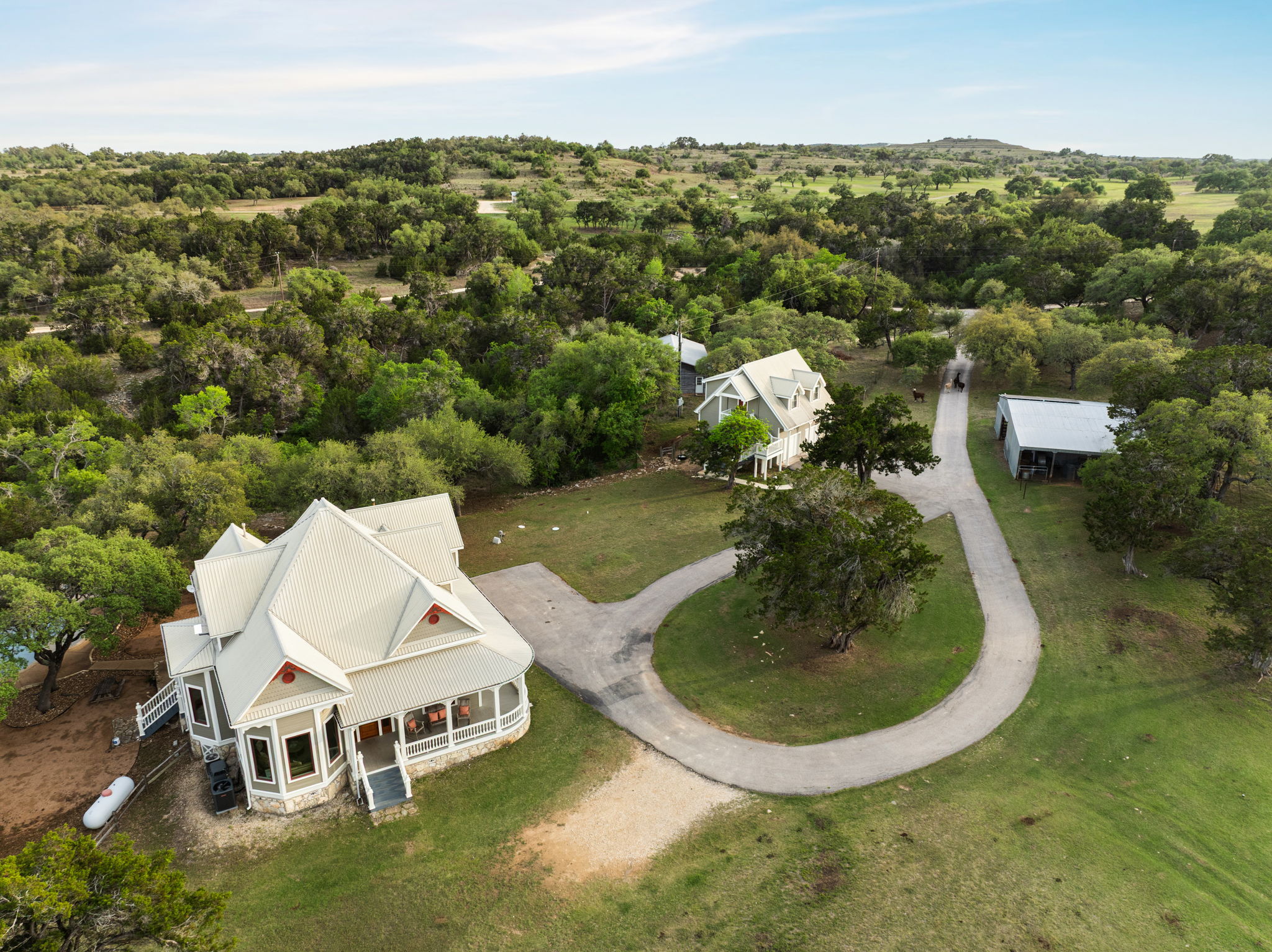 3409 Gatlin Creek Road Dripping Springs, TX 78620 - Photo 39 of 40 an aerial view of a house with a yard and lake view