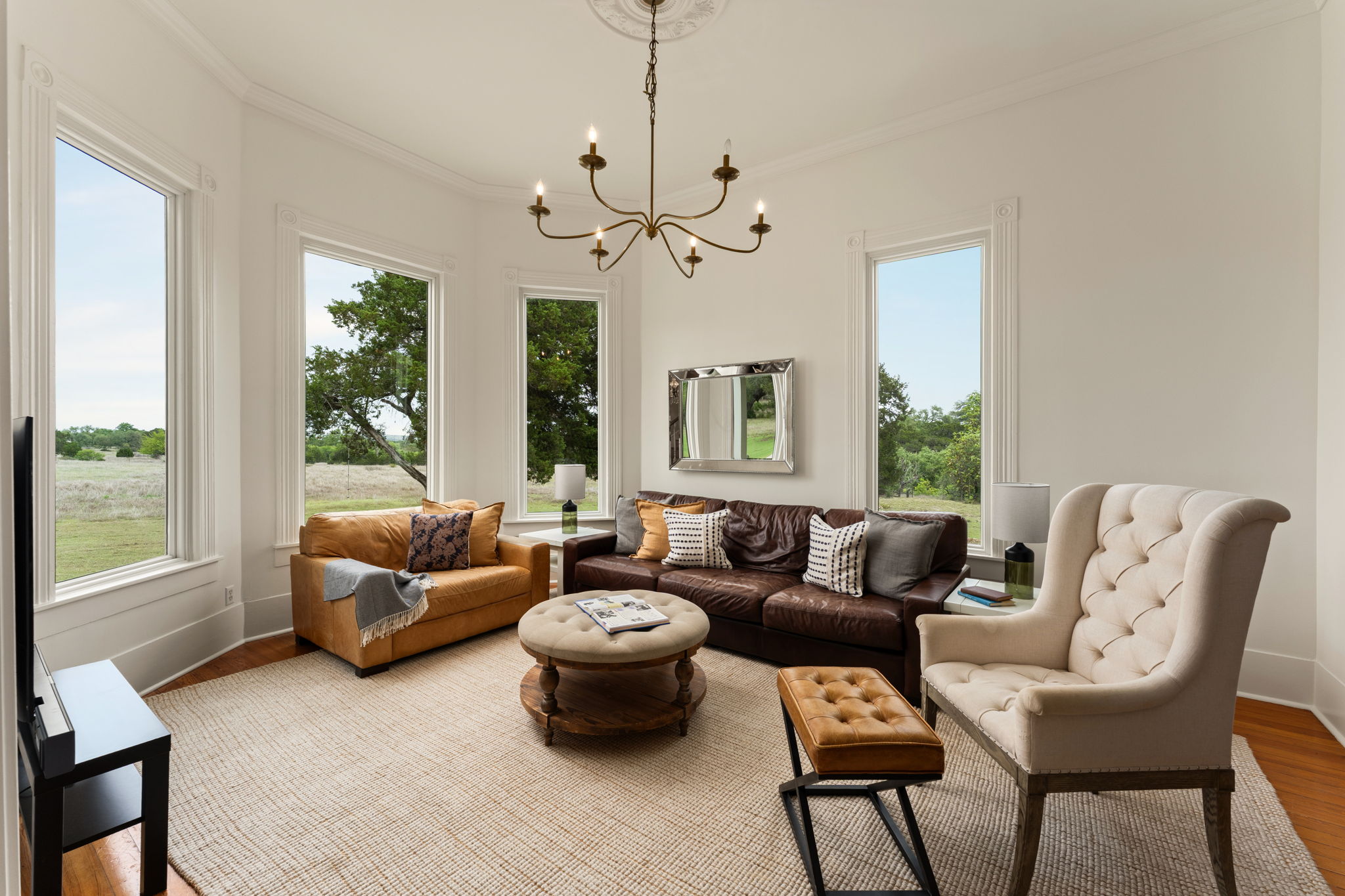 3409 Gatlin Creek Road Dripping Springs, TX 78620 - Photo 7 of 40 a living room with furniture a large window and a chandelier