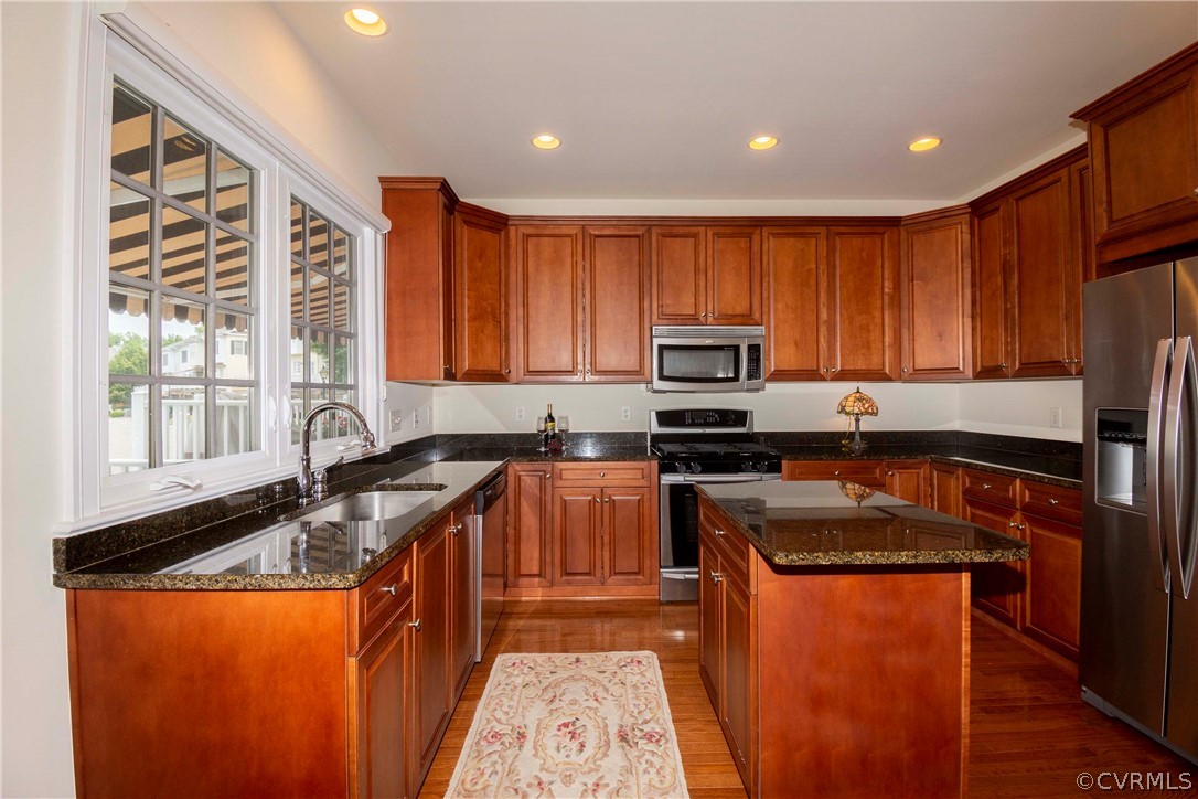 1122 Hyde Lane Henrico, VA 23229 - Photo 14 of 50 a kitchen with granite countertop wooden cabinets a sink stove and refrigerator