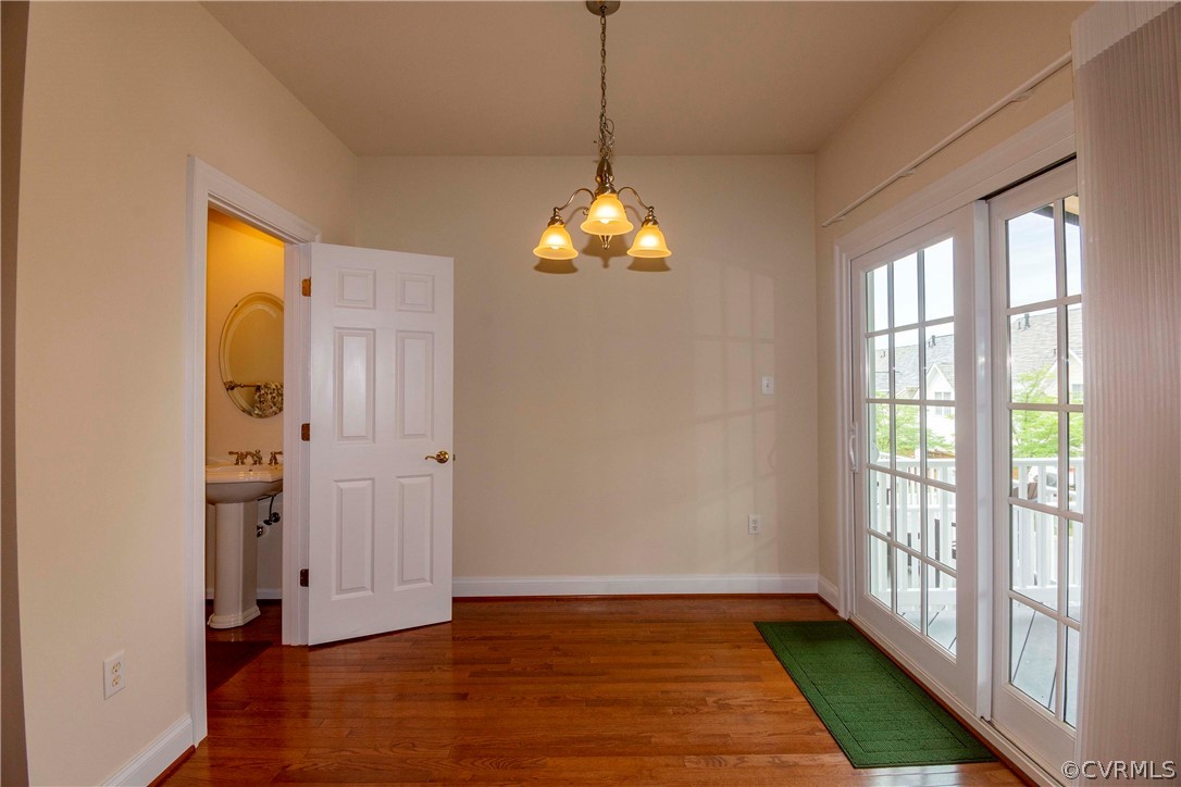 1122 Hyde Lane Henrico, VA 23229 - Photo 17 of 50 a hallway with wooden floor chandelier and a window