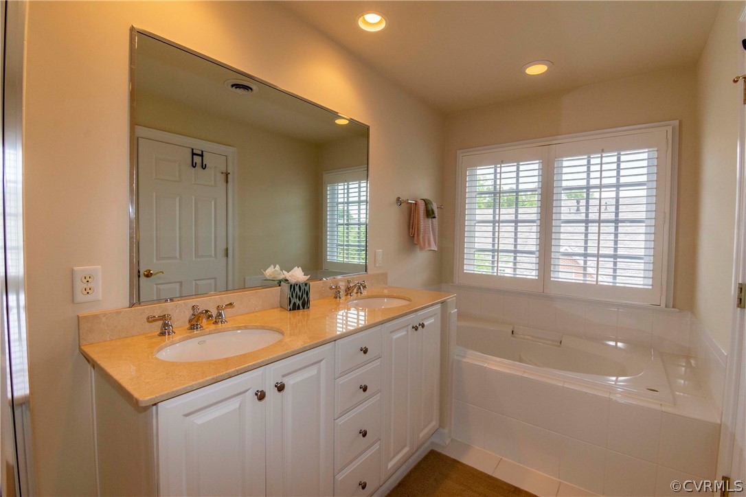 1122 Hyde Lane Henrico, VA 23229 - Photo 24 of 50 a bathroom with a tub sink double vanity and mirror